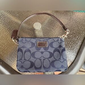 Coach navy blue wristlet with brown leather strap, silver hardware used